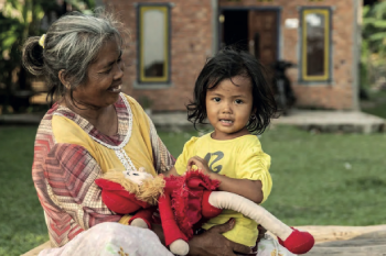 Woman looking at a child and her doll